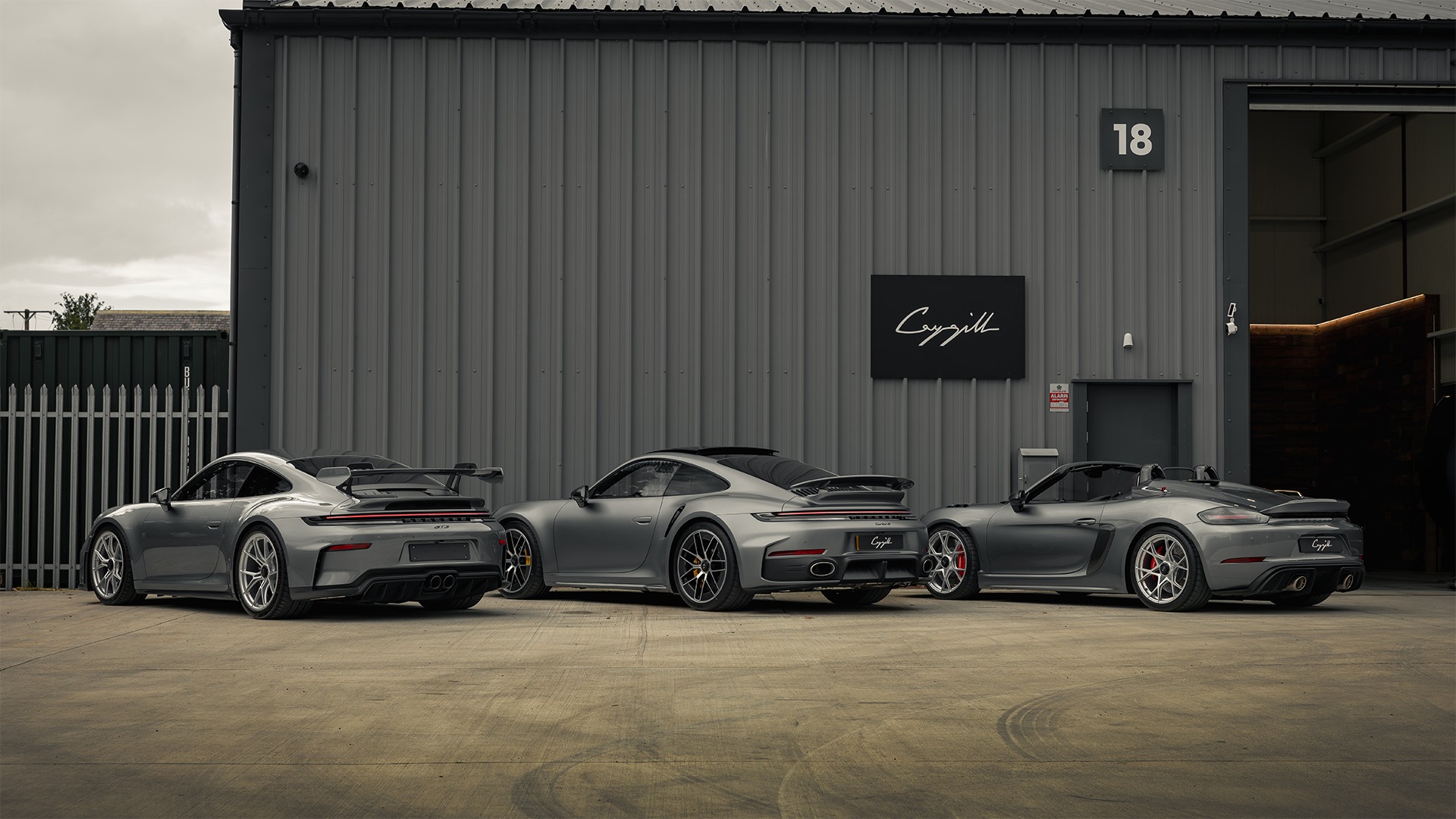 workshop Three Porsche cars outside the Caygill workshop